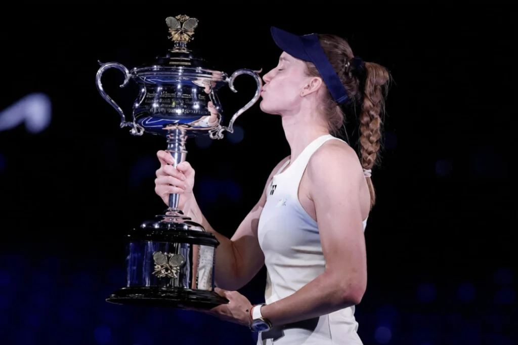 Elena Rybakina lifting champion trophy after beating Aryna Sabalenka in the Australian Open 2026